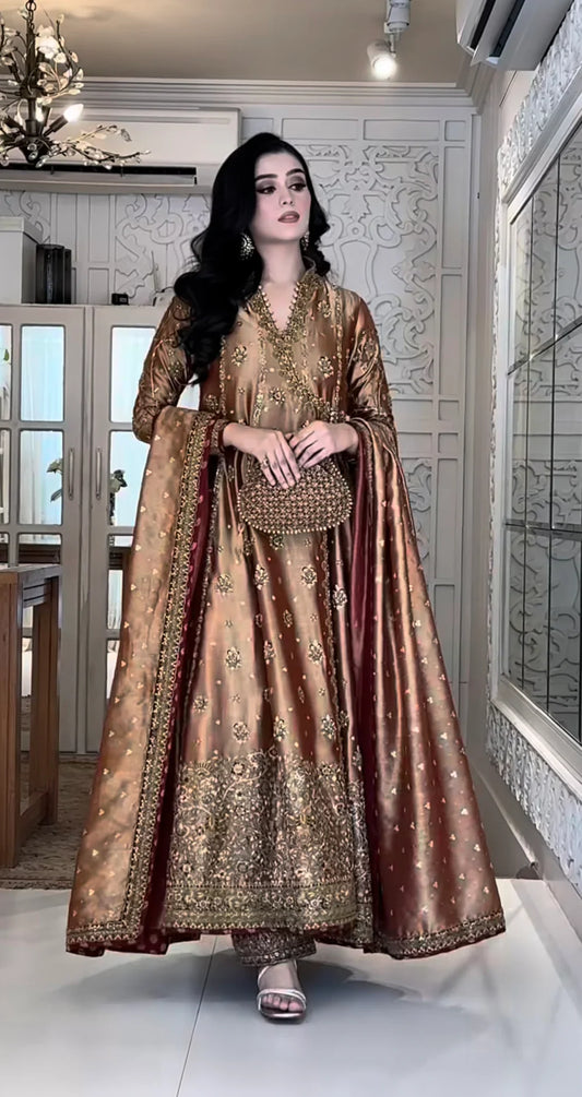 Haris Shakeel Aswad bronze-gold formal ensemble featuring intricate hand embellishments with detailed floral motifs, delicate sequins, and refined accents on an elongated silhouette with a heavily worked hemline, perfect for weddings, receptions, formal dinners, and festive celebrations.