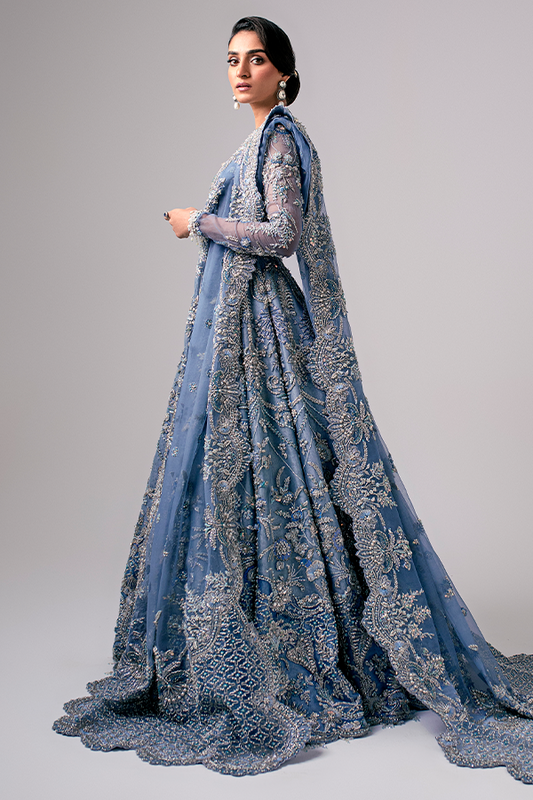The Nyra Couture Aarzu sky blue net lehenga choli featuring heavy florid embroidery with resham thread, naqshi, dabka, sequin, and pearls, paired with a heavy net dupatta, perfect for wedding celebrations and bridal events.