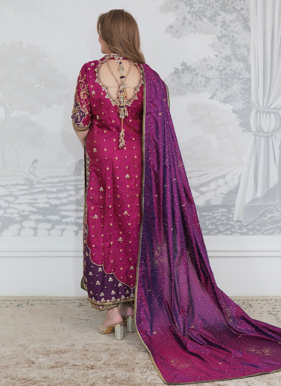 Farah Talib Aziz Bita magenta pure silk kurta featuring intricate hand embellishments with resham, zari, and sequins on the neckline, sleeves, daaman, and borders, paired with a luxurious purple tissue chaadar richly worked with golden embellishments and subtle shimmer accents, perfect for festive gatherings and formal occasions.