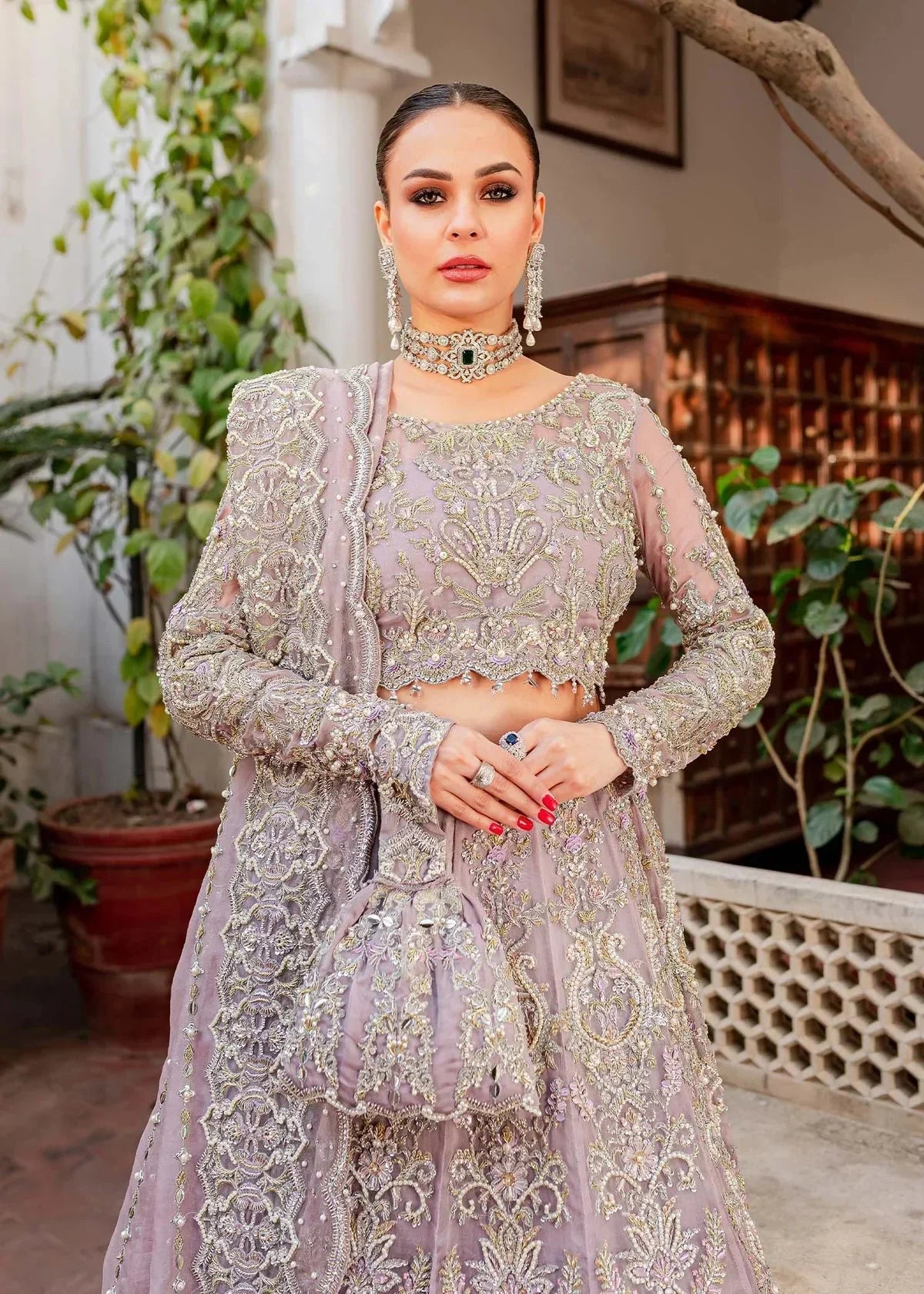 Kanwal Malik Zaarish lilac organza lehenga choli featuring heavy embroidery and hand embellishments with naqshi, dabka, crystals, pearls, and sequin in a blend of floral and geometrical patterns, paired with an organza dupatta adorned with a four-sided embellished border and vertical embellished lines at the center with extended pallu, perfect for weddings and formal occasions.