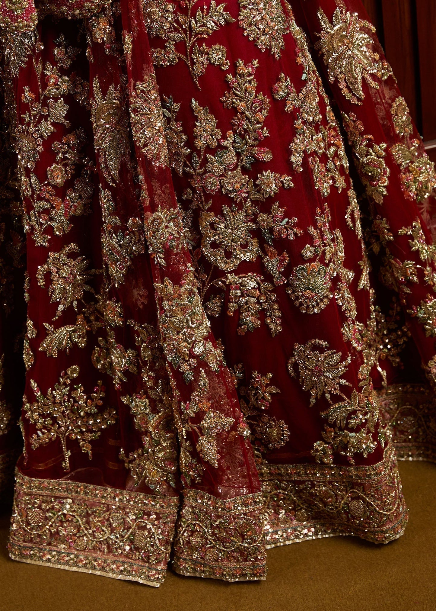 Hussain Rehar Qashqaye deep maroon lehenga choli featuring exquisite handwork that shimmers with delicate light, with a voluminous lehenga paired with an intricately worked choli, perfect for bridal wear and grand wedding celebrations.