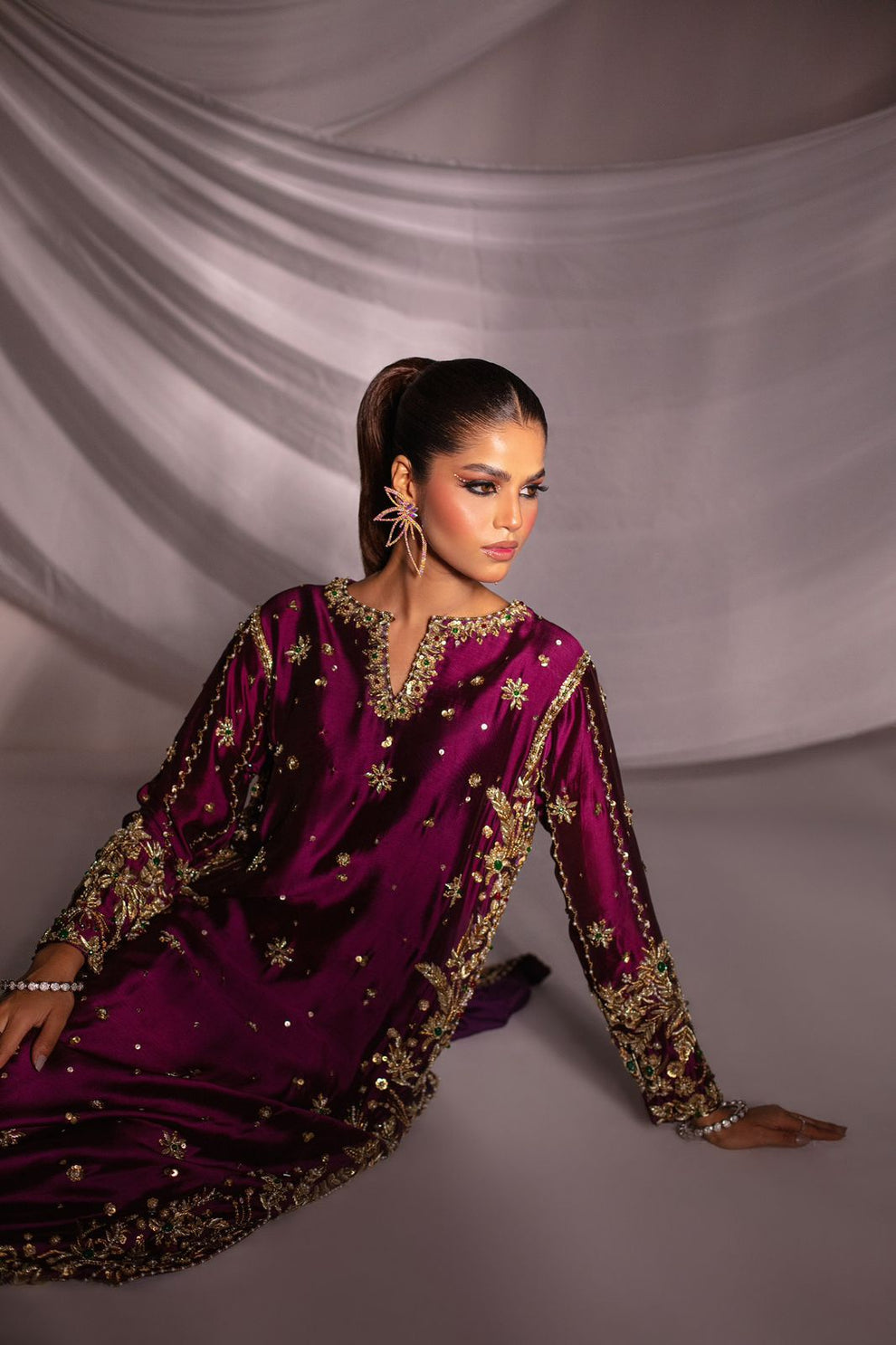 Batik Expressive Magenta dreamy magenta ensemble featuring a straight long heavily embellished shirt with zardozi techniques, stones, and beading, perfect for wedding festivities and formal occasions.