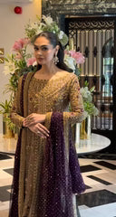 Haris Shakeel Aroha brushed bronze wedding ensemble featuring a luminous antique gold and soft champagne formal outfit with intricate hand embellishments and detailed embroidery, paired with a rich deep purple dupatta for a regal contrast, perfect for weddings, receptions, engagements, and formal celebrations.