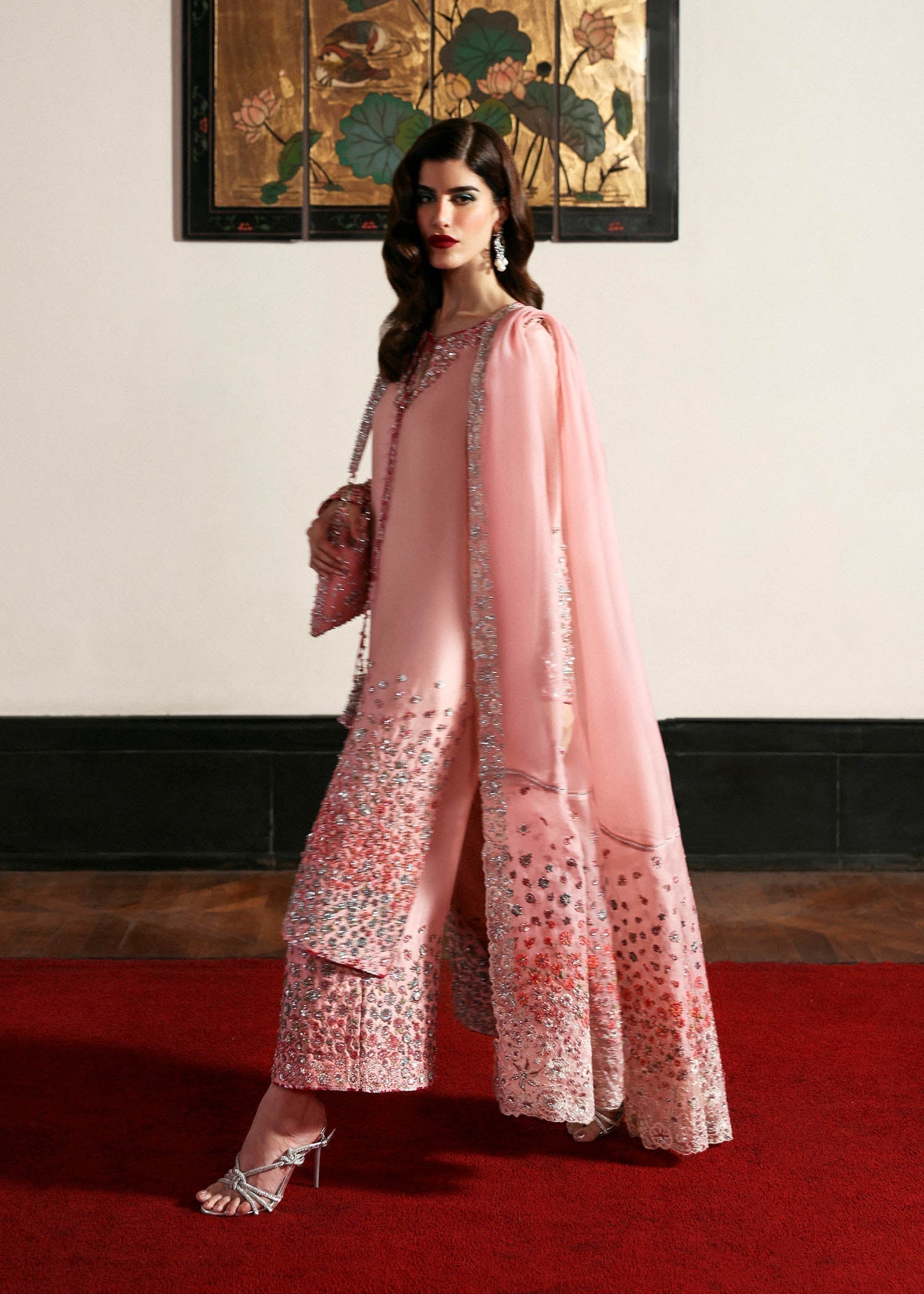 Hussain Rehar Evara ensemble featuring intricate embellishments with refined detail on rich flowing fabric in a statement silhouette with bold accents and a perfectly tailored cut, paired with a graceful dupatta, perfect for weddings and formal occasions.