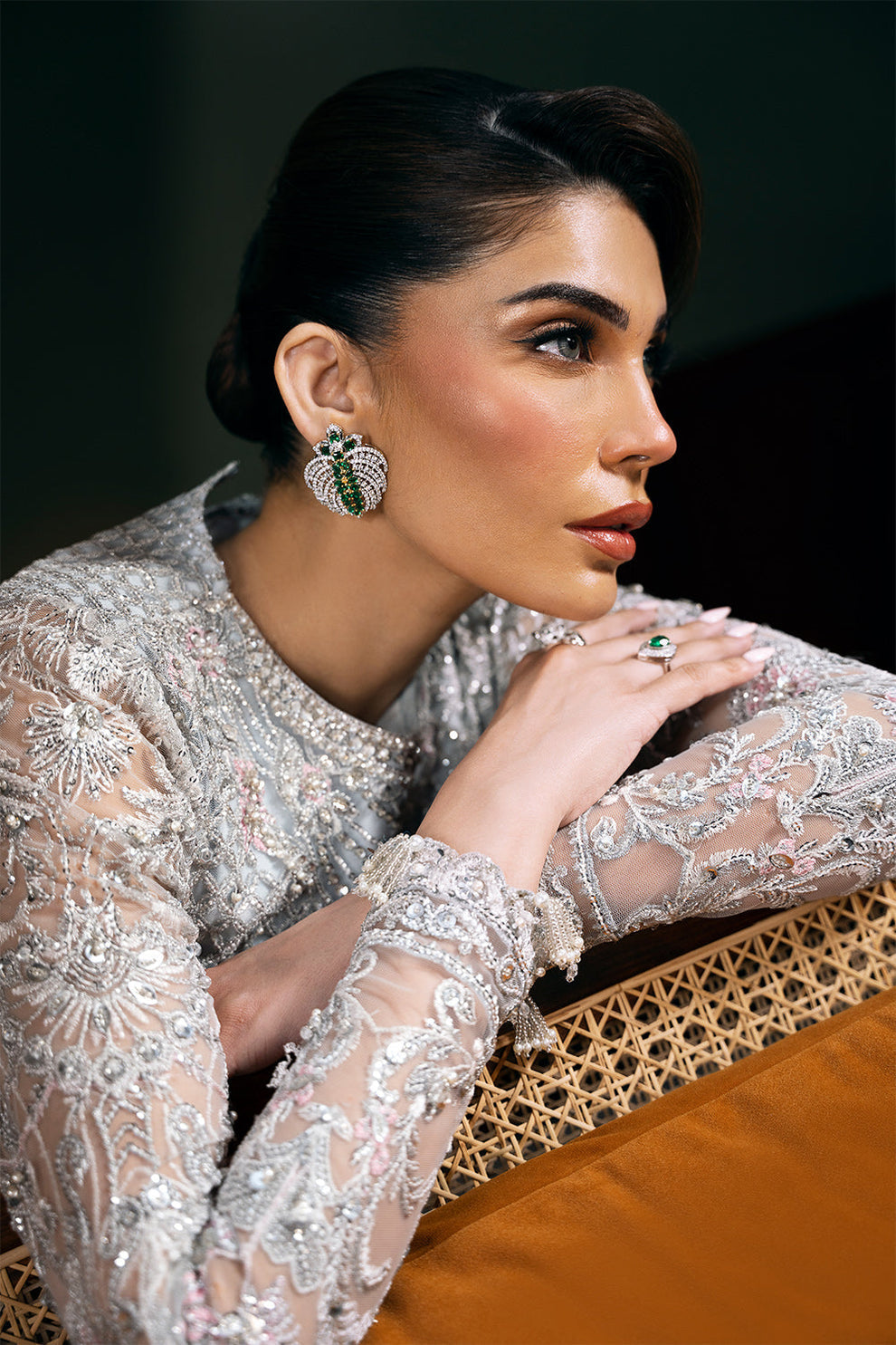 Saira Rizwan Kylo unstitched net ensemble featuring embroidered sequined and embellished front, back, sleeves, and panels, paired with an embroidered sequined net dupatta and raw silk lehenga with lining, perfect for weddings and formal occasions.