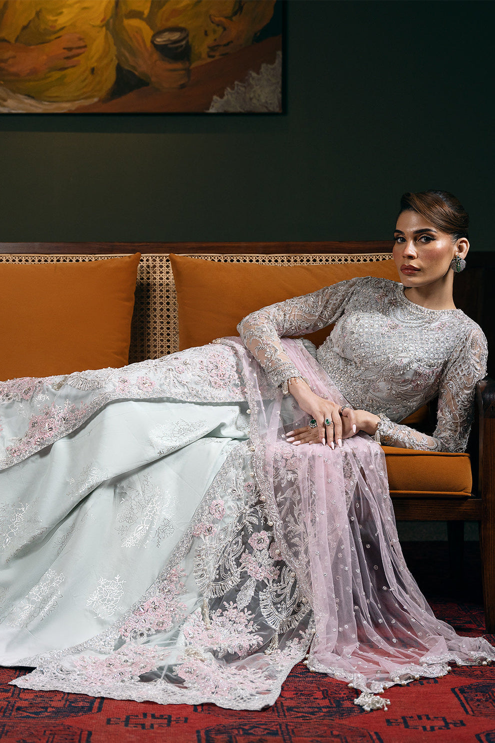 Saira Rizwan Kylo unstitched net ensemble featuring embroidered sequined and embellished front, back, sleeves, and panels, paired with an embroidered sequined net dupatta and raw silk lehenga with lining, perfect for weddings and formal occasions.