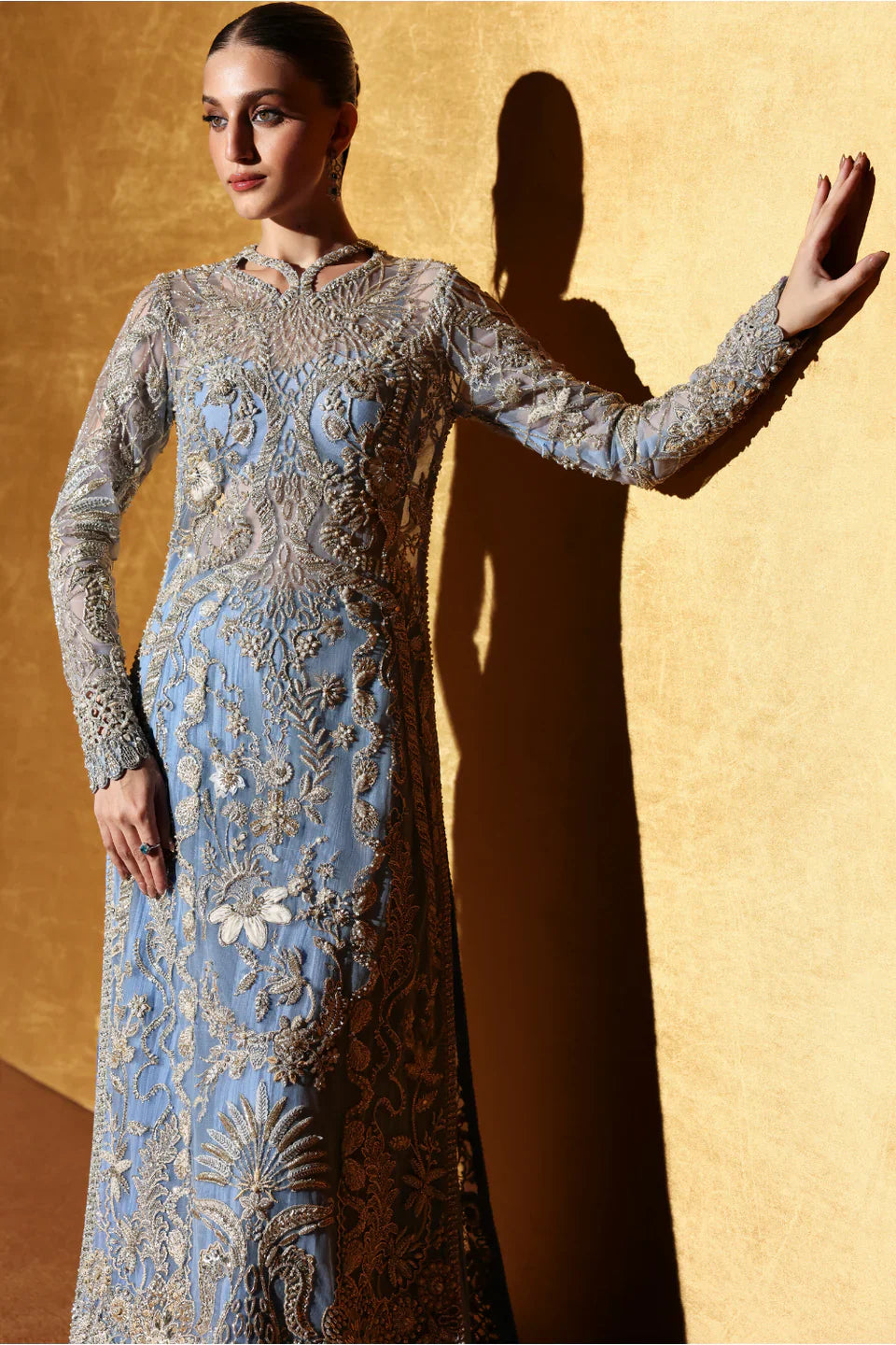 Soraya inspired Seralyn luxury formal ensemble in a soft ethereal pastel palette with subtle warm undertones featuring intricate hand embellishments and shimmering accents on a flowing silhouette with a richly worked bodice and embellished flare, paired with a coordinated dupatta with elegant borders, perfect for weddings and formal celebrations.