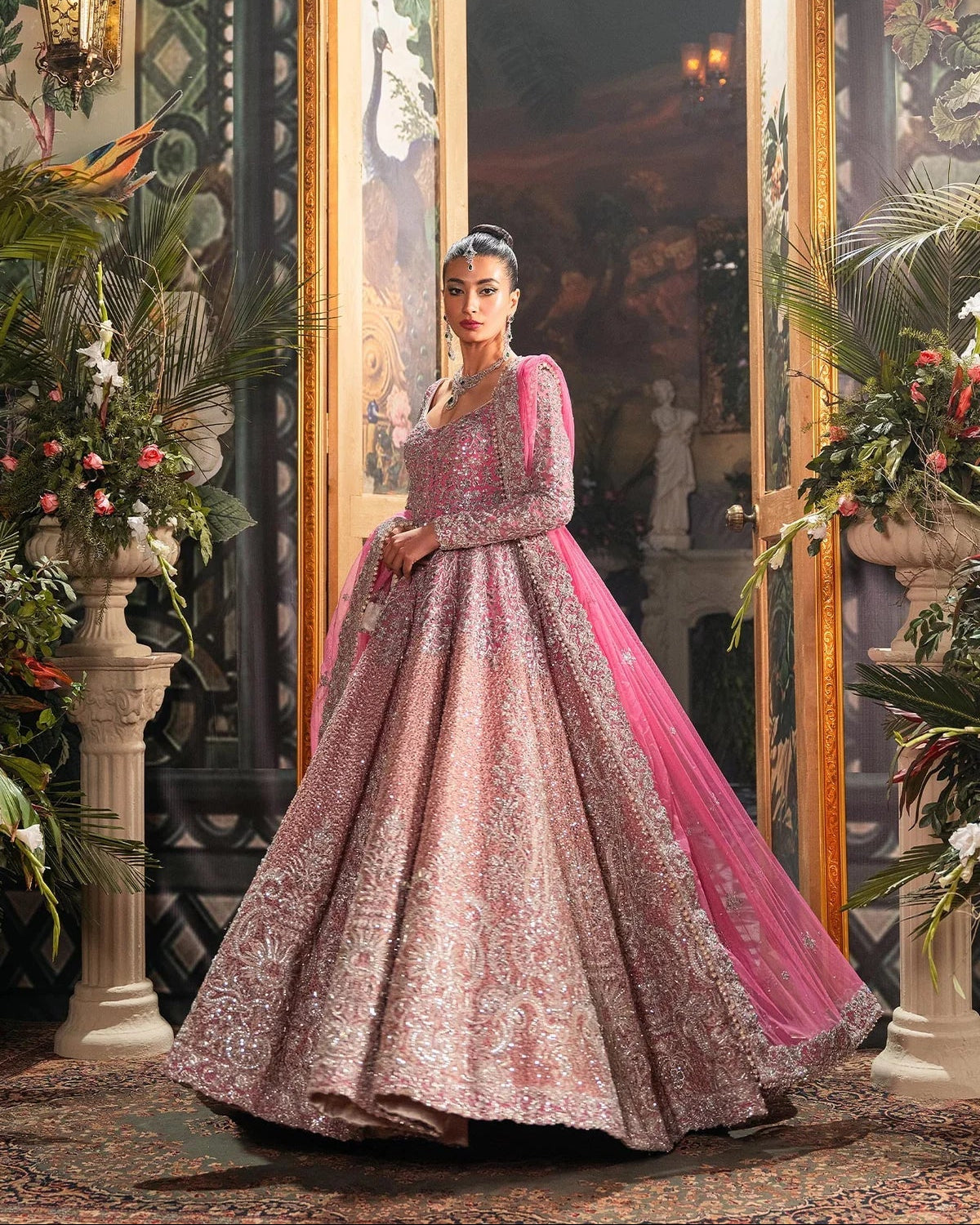  Fahad Hussayn Bagaai pink net bridal lehenga choli featuring intricate resham embroidery, fine sequin detailing, elaborate zardozi work, and hand-placed crystals on a delicate net fabric base, with a flowing embroidered lehenga, coordinated choli, and matching dupatta, perfect for wedding ceremonies, receptions, and grand bridal events.