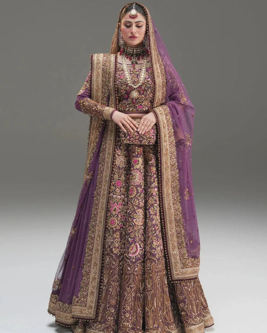 Fahad Hussayn Mirbail wine net lehenga choli featuring a structured corset-style blouse with intricate embroidery and handwork embellishments, paired with a flowing net lehenga in rich wine color and a lightweight net dupatta with an exquisitely embellished border, perfect for bridal wear, weddings, receptions, and festive celebrations.