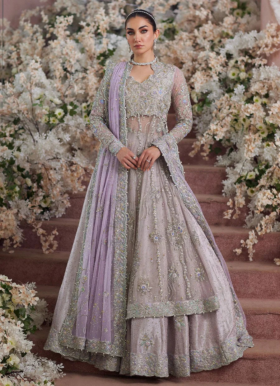 Farah Talib Aziz Elanur lilac bridal kalidaar crafted on pure net with intricate hand embellishments featuring a flared silhouette, paired with a classic lehenga and coordinated net dupatta with subtle embroidery, perfect for wedding festivities and formal celebrations.
