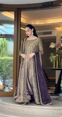 Haris Shakeel Aroha brushed bronze wedding ensemble featuring a luminous antique gold and soft champagne formal outfit with intricate hand embellishments and detailed embroidery, paired with a rich deep purple dupatta for a regal contrast, perfect for weddings, receptions, engagements, and formal celebrations.