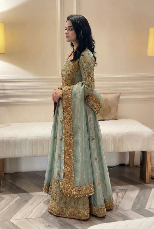 Haris Shakeel Urooj unstitched 3-piece bridal ensemble from the Wedding Luxury Myssory collection featuring exquisite hand embellishments and intricate embroidery with rich textures and sophisticated patterns that blend traditional bridal aesthetics with contemporary flair, crafted in premium quality fabric for customizable tailoring to create a regal wedding look.
