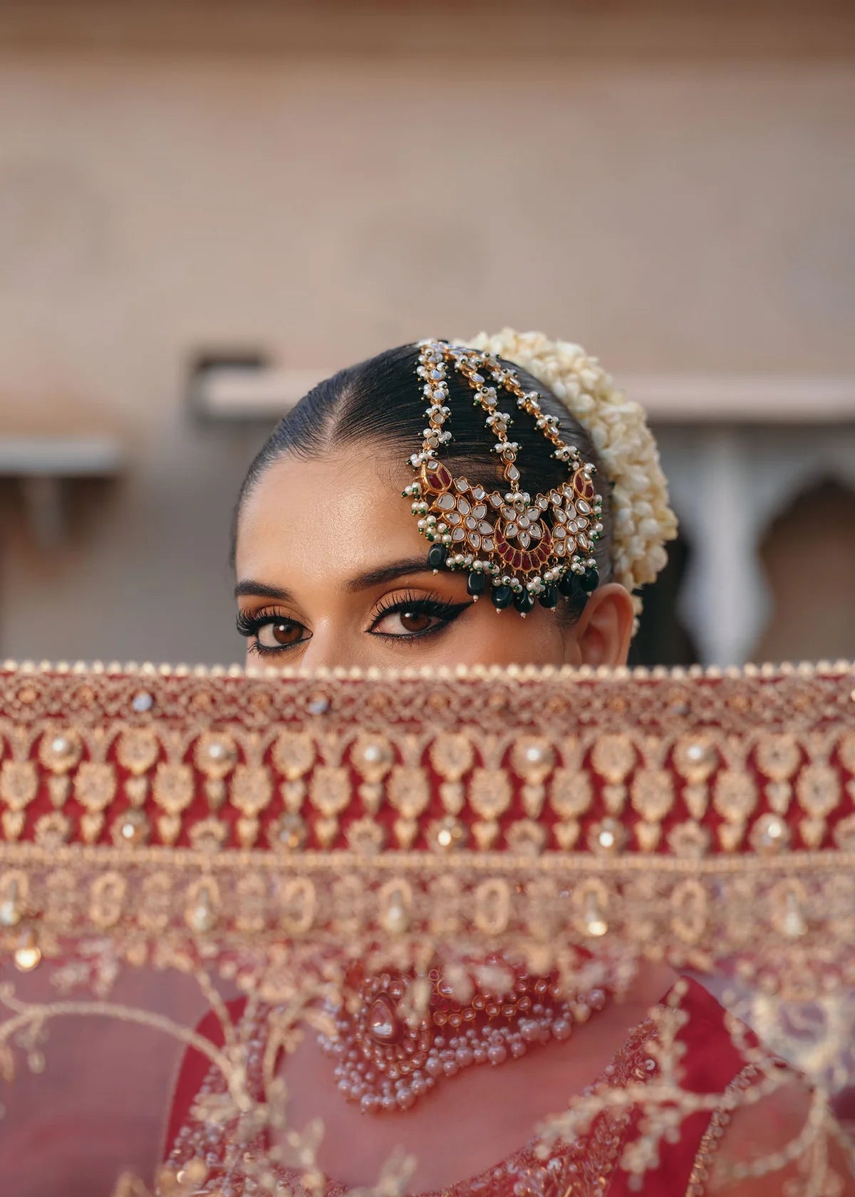 Mehek red ada embroidery Pakistani formal three-piece ensemble featuring a tissue silk shirt with a square neckline and intricate traditional embroidery, paired with matching tissue silk gharara and a kathan organza dupatta, perfect for weddings and festive celebrations.
