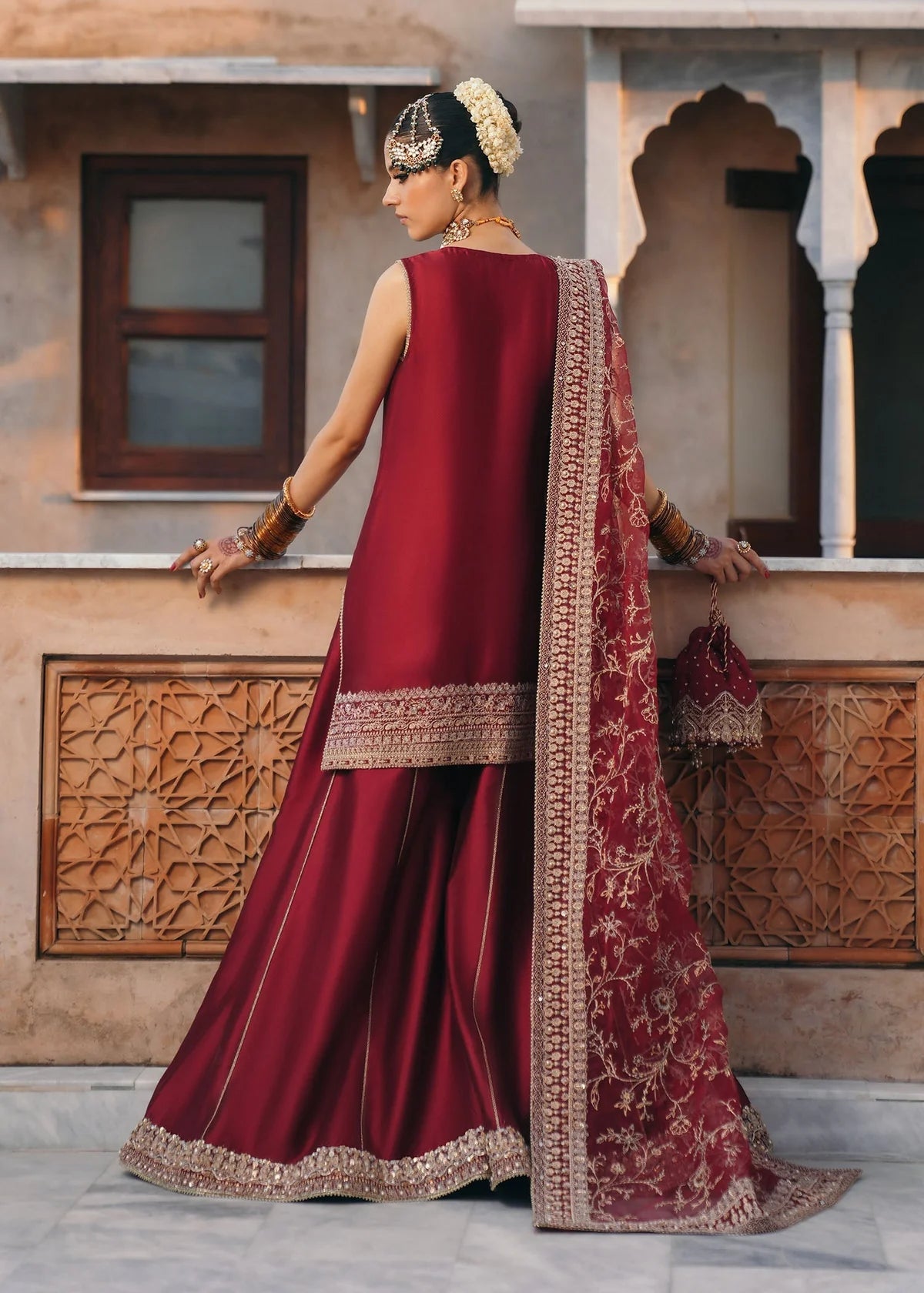 Mehek red ada embroidery Pakistani formal three-piece ensemble featuring a tissue silk shirt with a square neckline and intricate traditional embroidery, paired with matching tissue silk gharara and a kathan organza dupatta, perfect for weddings and festive celebrations.