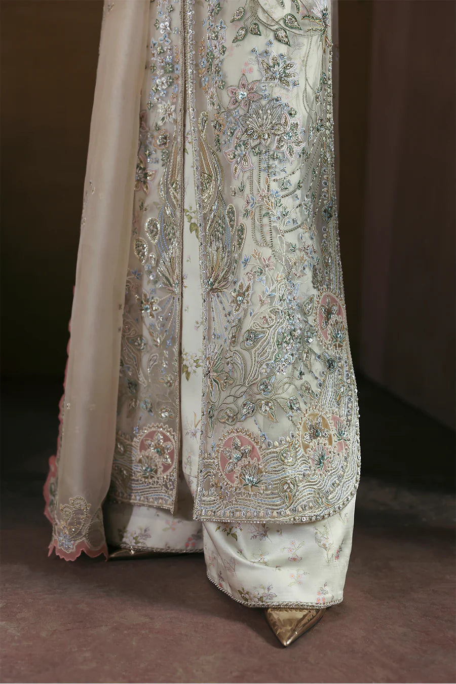 Soraya Novara ivory and gold formal ensemble featuring a beautifully embellished shirt with intricate handwork blending delicate thread embroidery, shimmering sequins, and fine embellishments on a soft ivory base with detailed gold accents, paired with a complementing dupatta, perfect for weddings, receptions, engagement ceremonies, and festive celebrations.