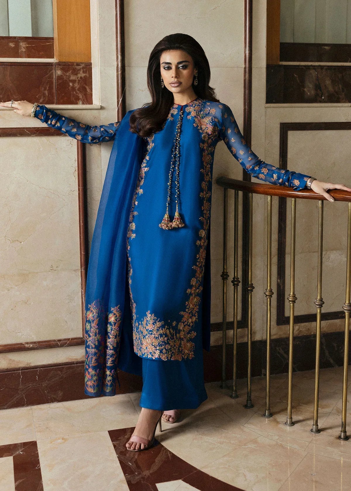 Hussain Rehar Serene teal blue raw silk shirt featuring vibrant screen-printed details with delicate embellishments and chic raglan sleeves in sheer screen-printed organza, paired with plain culottes and a matching screen-printed dupatta, perfect for festive gatherings and semi-formal events.