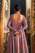  Fahad Hussayn Bagaai pink net bridal lehenga choli featuring intricate resham embroidery, fine sequin detailing, elaborate zardozi work, and hand-placed crystals on a delicate net fabric base, with a flowing embroidered lehenga, coordinated choli, and matching dupatta, perfect for wedding ceremonies, receptions, and grand bridal events.