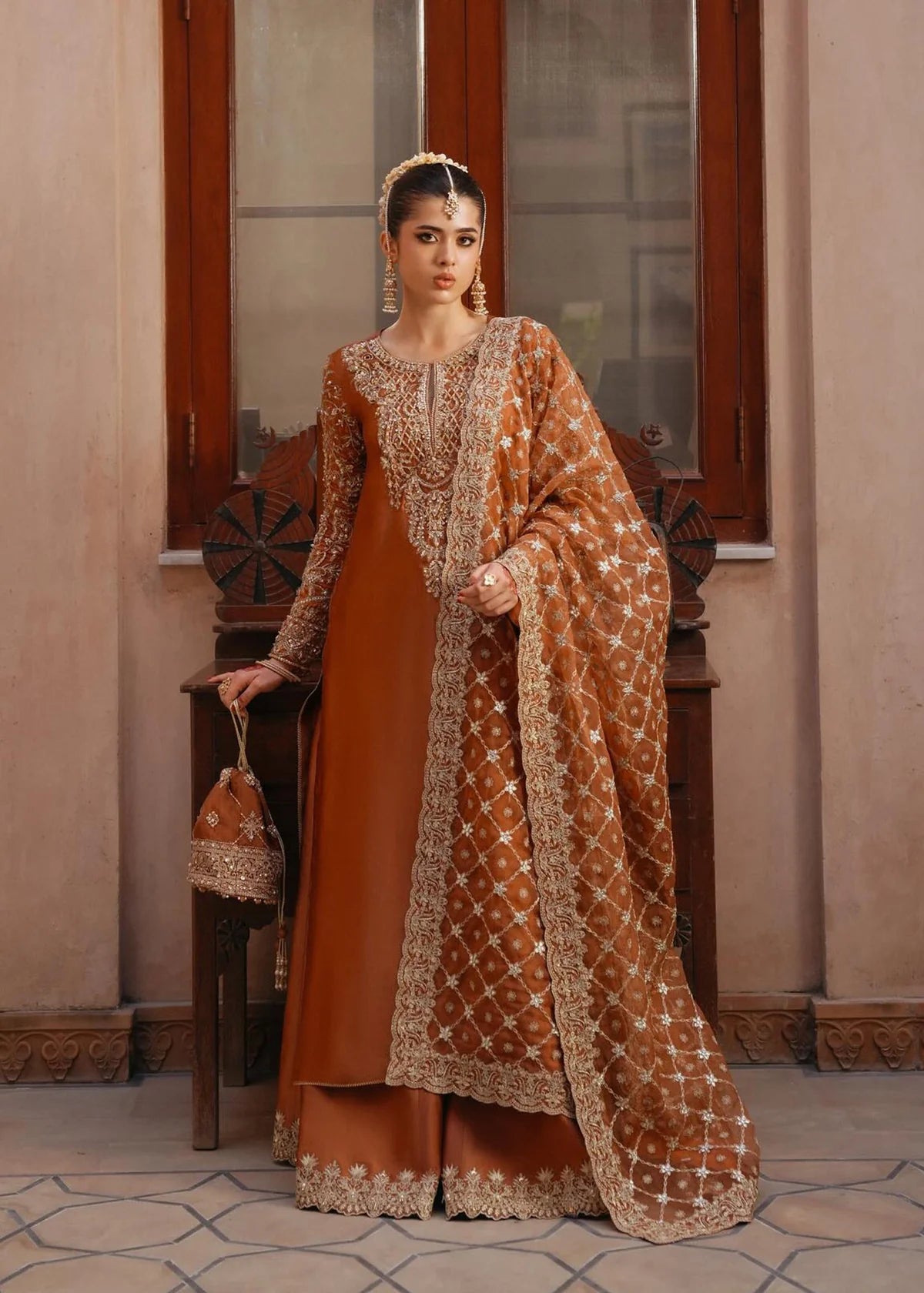  Zulekha Golden Mocha Pakistani formal three-piece ensemble featuring a long shirt in luxurious Korean silk with delicate embroidery on the neckline and sleeves, paired with matching flared trousers and a fully embroidered organza dupatta, perfect for festive evenings and elegant gatherings.